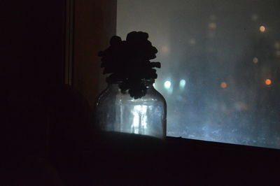 Silhouette of illuminated lamp at home