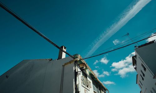 Low angle view of crane against blue sky