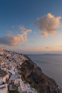 High angle view of townscape by sea against sky