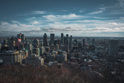 High angle view of buildings against cloudy sky