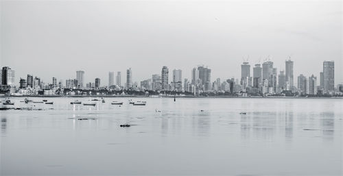 View of city buildings against clear sky