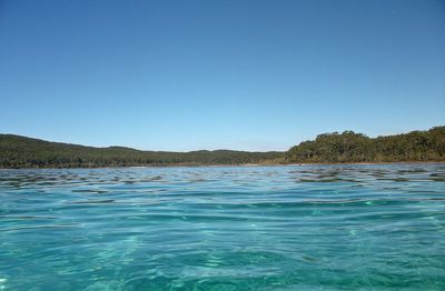 Scenic view of sea against clear blue sky