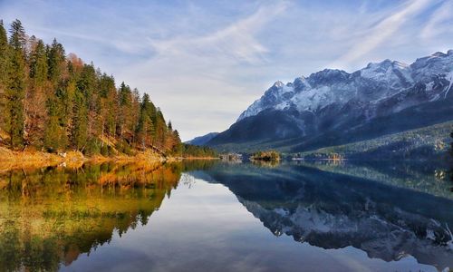 Scenic view of lake and mountains against sky