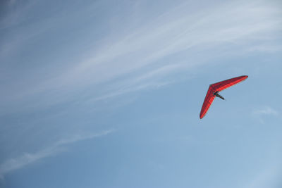 Low angle view of kite flying against blue sky