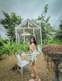 Full length of woman standing by plants