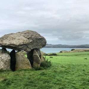 Scenic view of rocks on field against sky