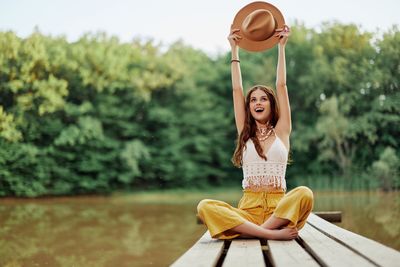 Portrait of young woman sitting on bench