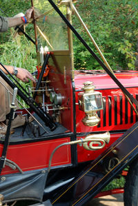 Cropped image of hand holding red car