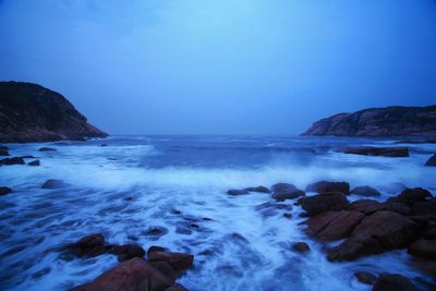 Scenic view of sea against clear blue sky