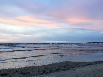 Scenic view of beach against sky during sunset