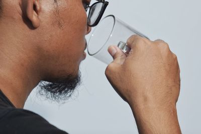 Close-up portrait of man holding mobile phone