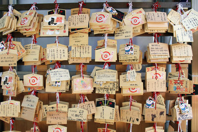 Full frame shot of text hanging outside temple