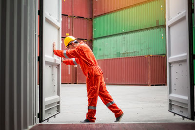 Full length of man working on metal