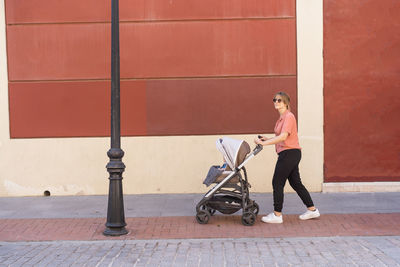 Young mother takes a walk with young baby