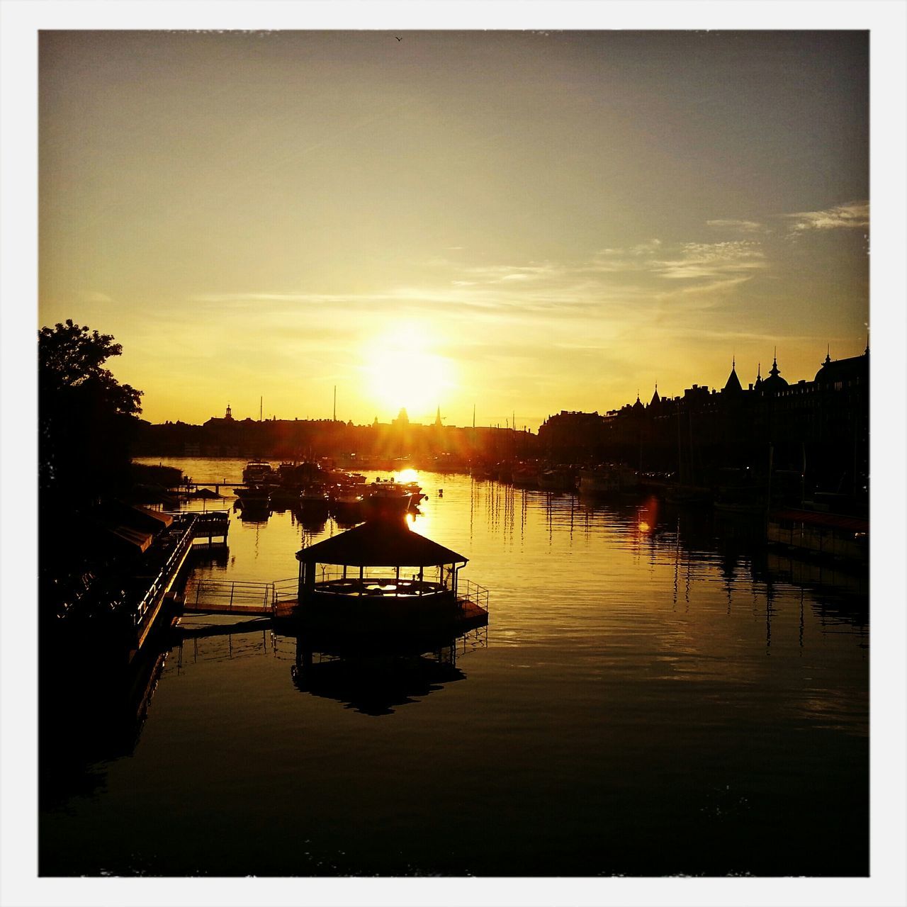 sunset, transfer print, nautical vessel, sun, water, transportation, mode of transport, boat, moored, sky, auto post production filter, sunlight, reflection, orange color, harbor, waterfront, river, silhouette, sunbeam, built structure