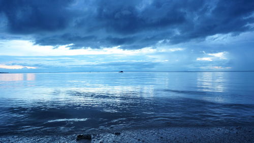 Scenic view of sea against cloudy sky