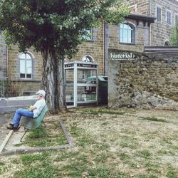 Woman standing outside house