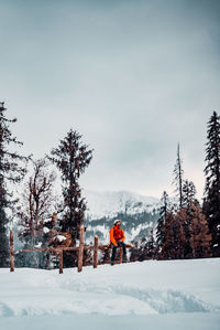 People skiing on snow covered landscape