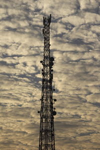 Low angle view of communications tower against sky