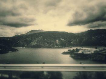 Scenic view of lake against cloudy sky