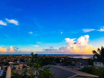 High angle view of buildings against blue sky