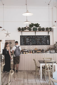 Men standing on table