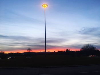 Illuminated trees against sky at night