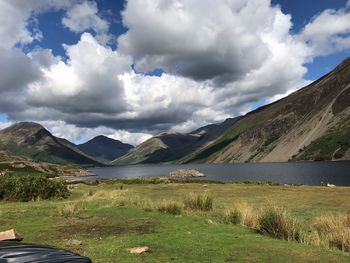 Scenic view of field and mountains against sky