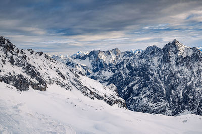 Scenic view of snowcapped mountains against sky during winter