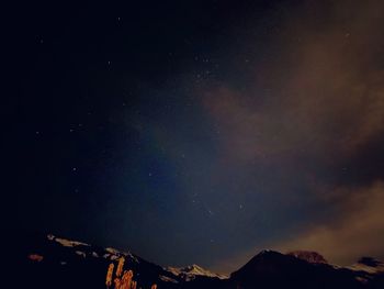 Low angle view of mountain against sky at night