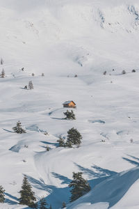 A picturesque view of a remote house in the snowcapped french alps mountains