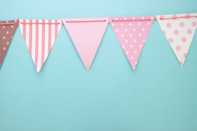 Multi colored umbrellas hanging against blue background