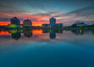 Reflection of buildings in lake during sunset