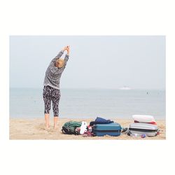 Boy on beach against clear sky