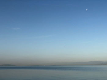 Scenic view of sea against clear blue sky