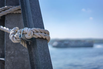 Close-up of rope tied to wooden post