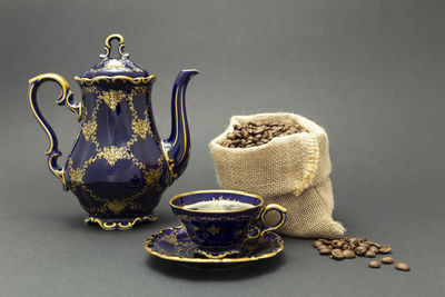 Close-up of tea cup on table against gray background