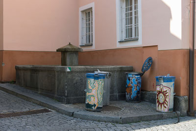 Garbage can on street by building