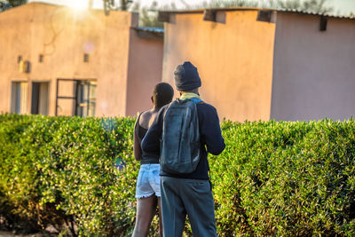 Rear view of man and son on plants