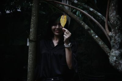 Young woman using mobile phone at night