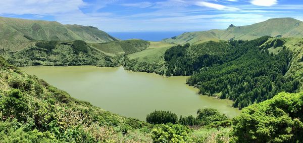 Scenic view of lake and mountains against sky