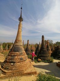 Statue of temple against cloudy sky