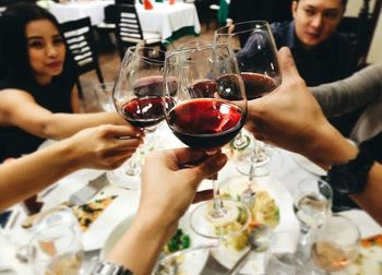 Close-up of woman holding drink in restaurant