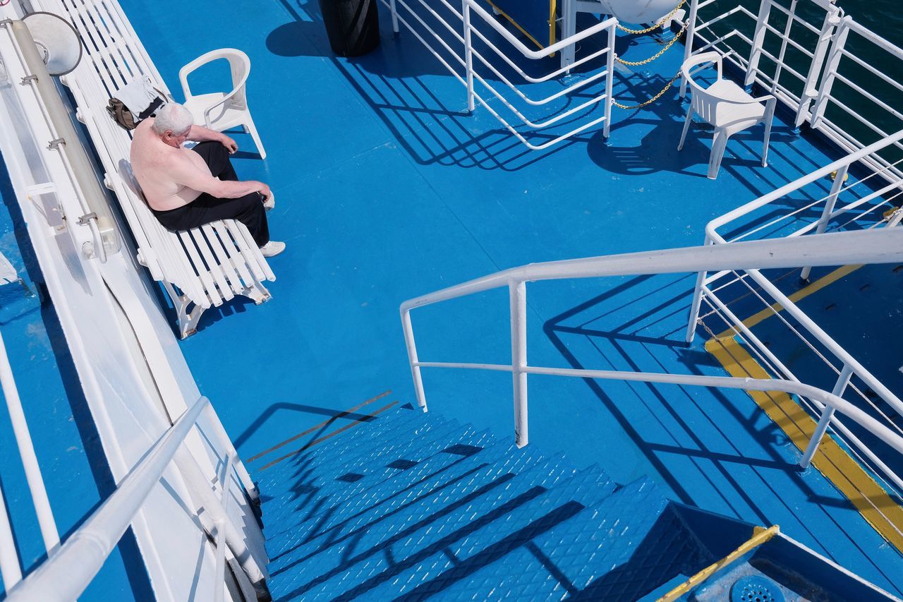 pool, water, swimming pool, blue, nature, real people, one person, lifestyles, high angle view, railing, day, architecture, leisure activity, deck, hand, sunlight, staircase, human hand, outdoors, ladder