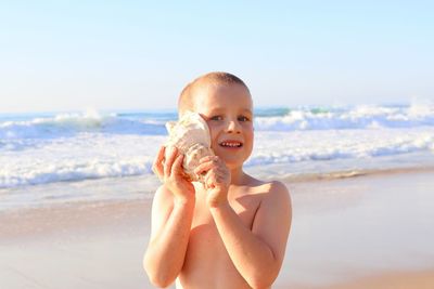 Portrait of boy playing at beach