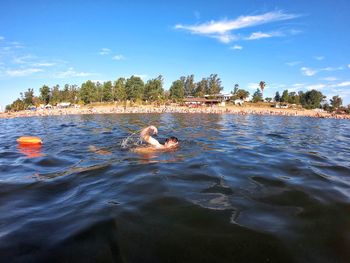 View of dog swimming in lake