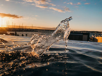 Aerial view of frozen sea against sky during sunset