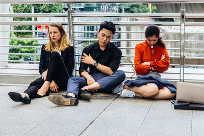 Portrait of young couple sitting outdoors