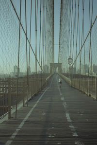 Man running on suspension bridge