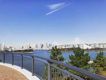 Bridge over river against sky in city